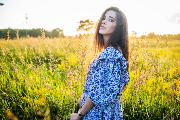 Giovane bella ragazza europea al tramonto, sul campo