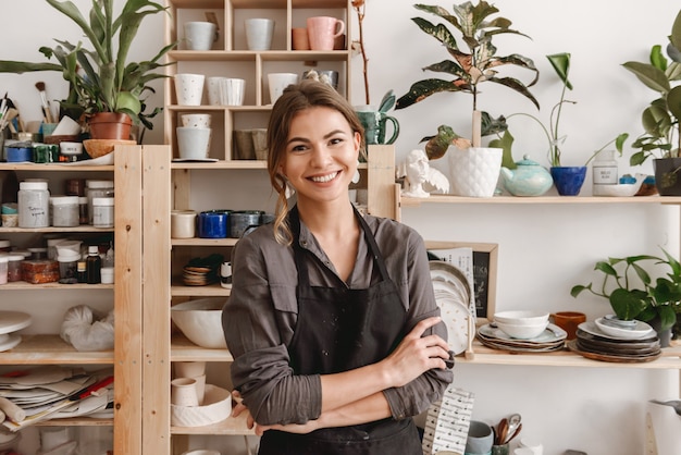 Giovane ceramista femminile sorridente felice