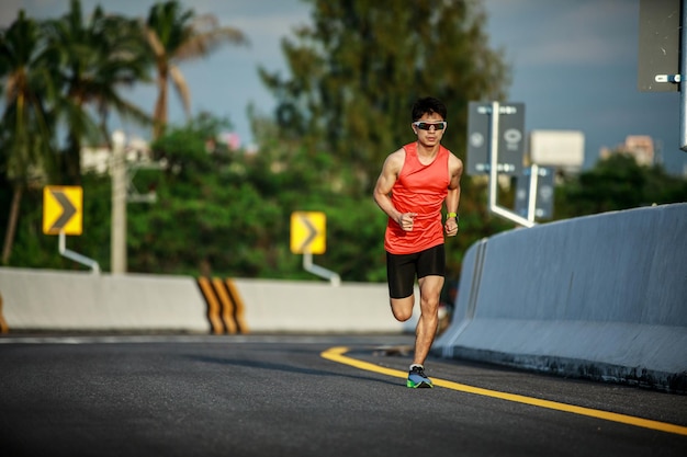 Giovane che corre sulla strada al mattino