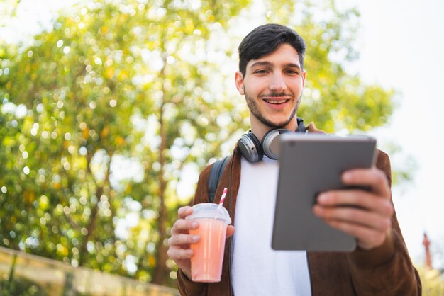 Giovane che per mezzo della sua compressa digitale