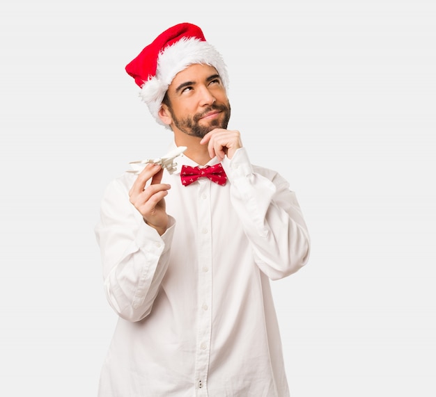 Giovane che porta un cappello del Babbo Natale il giorno di Natale