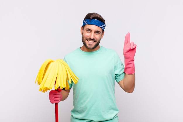 Giovane che sembra felice, fiducioso e degno di fiducia, sorridente e mostrando segno di vittoria, con un atteggiamento positivo