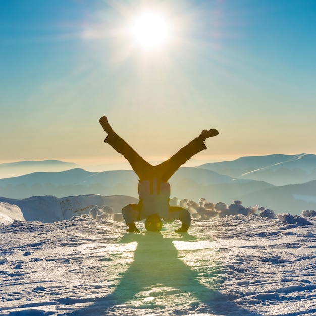 Giovane che si diverte sulla neve in montagna