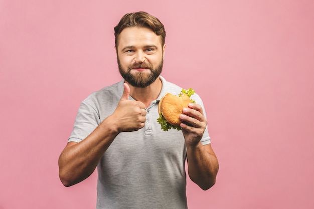 Giovane che tiene un pezzo di hamburger