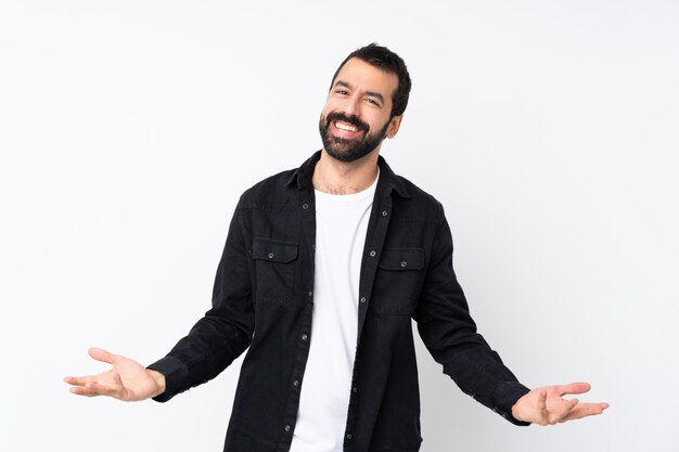 Giovane con la barba sopra sorridere bianco isolato della parete