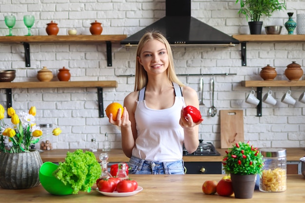 Giovane donna a dieta, una donna vegetariana prepara un'insalata