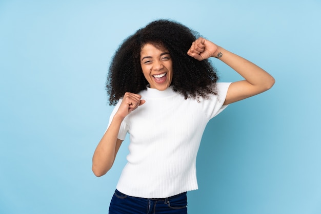 Giovane donna afroamericana isolata che celebra una vittoria