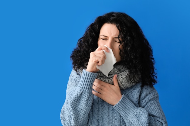 Giovane donna ammalata sulla superficie di colore