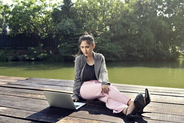 Giovane donna asiatica di affari che lavora con il computer portatile