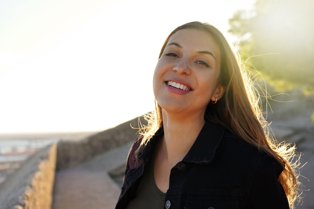 Giovane donna brasiliana che sorride al tramonto