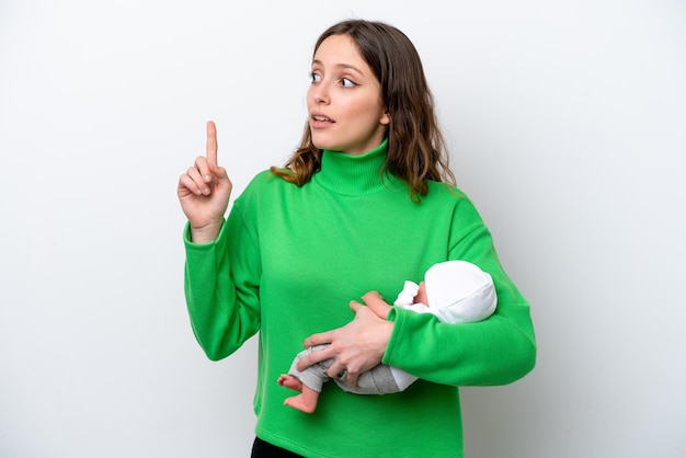 Giovane donna caucasica con il suo bambino carino isolato su sfondo bianco con l'intenzione di realizzare la soluzione sollevando un dito