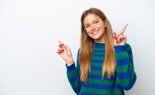Giovane donna caucasica isolata su sfondo bianco che punta il dito sui laterali e felice