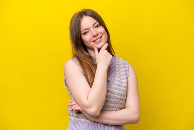 Giovane donna caucasica isolata su sfondo giallo felice e sorridente