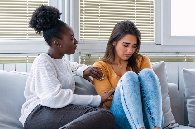 Giovane donna che consola la sua amica a casa