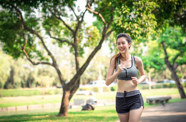 Giovane donna che corre nel concetto di sport e ricreazione del parco