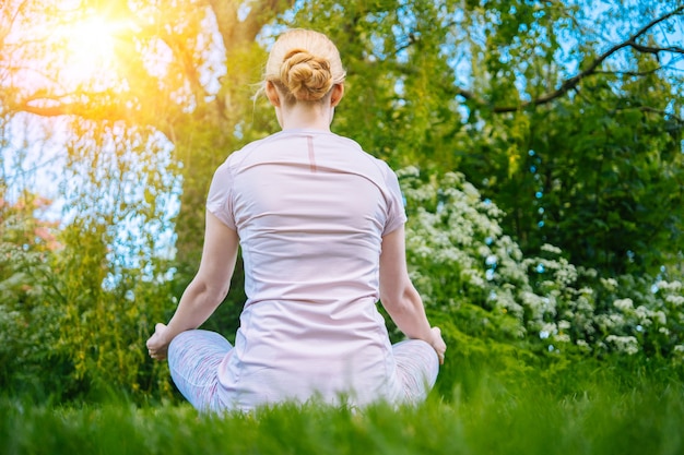 Giovane donna che fa yoga asana nel parco ragazza che allunga esercizio in posizione yoga felice donna in buona salute