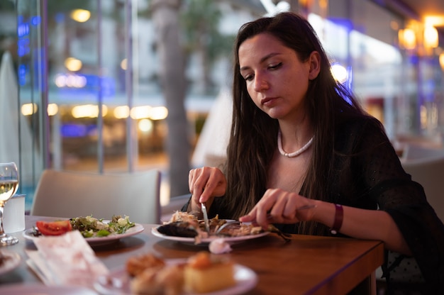 Giovane donna che gode della prima colazione nel ristorante.