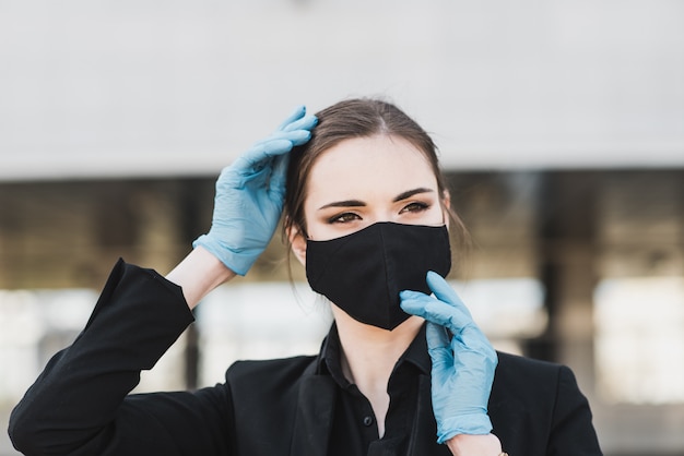 giovane donna che indossa la maschera protettiva viso nero all'aperto