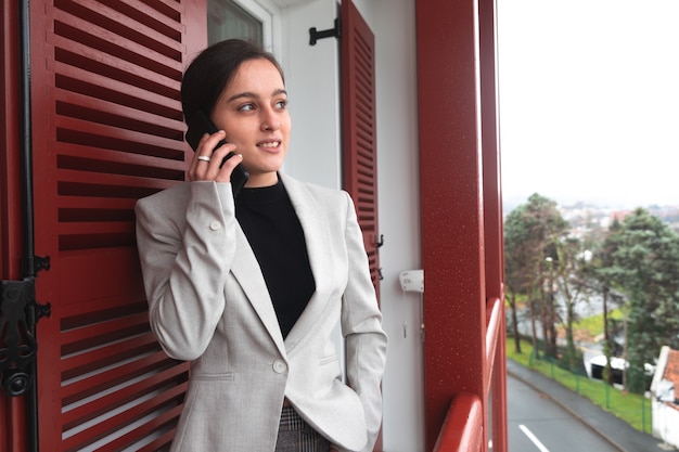 Giovane donna che parla con il suo telefono cellulare sulla terrazza.