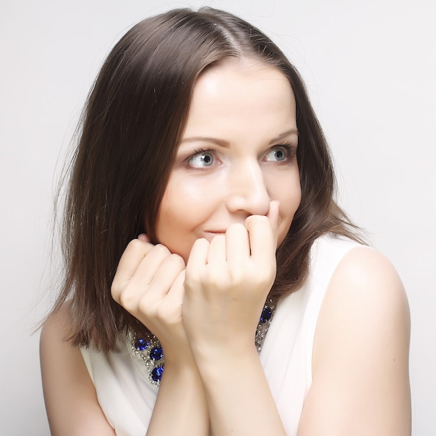 Giovane donna con le mani sulla bocca. Sorpresa!