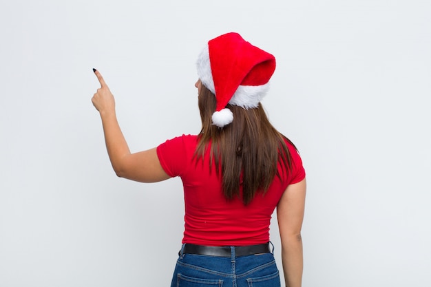 Giovane donna graziosa con cappello santa. Concetto di natale.