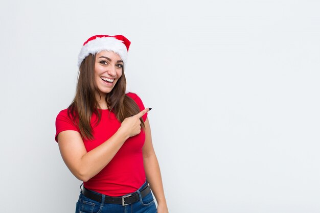 Giovane donna graziosa con cappello santa. Concetto di natale.