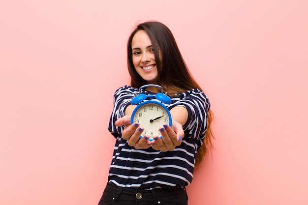 Giovane donna graziosa con un orologio. concetto di tempo