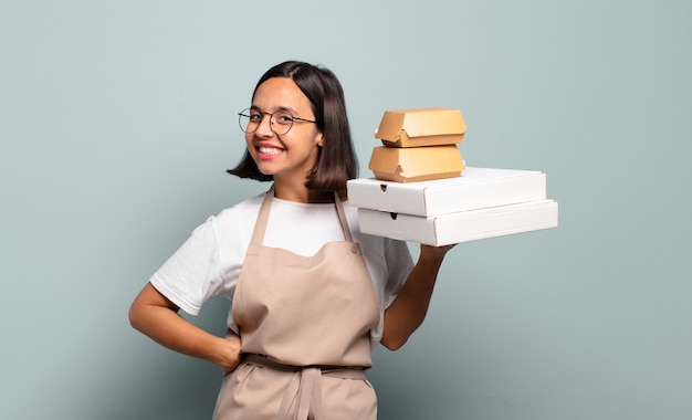 Giovane donna graziosa del cuoco unico. concetto di fast food