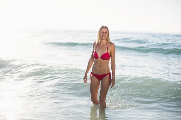 Giovane donna in bikini che sta in acqua