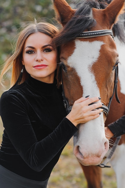 Giovane donna in posa con un cavallo