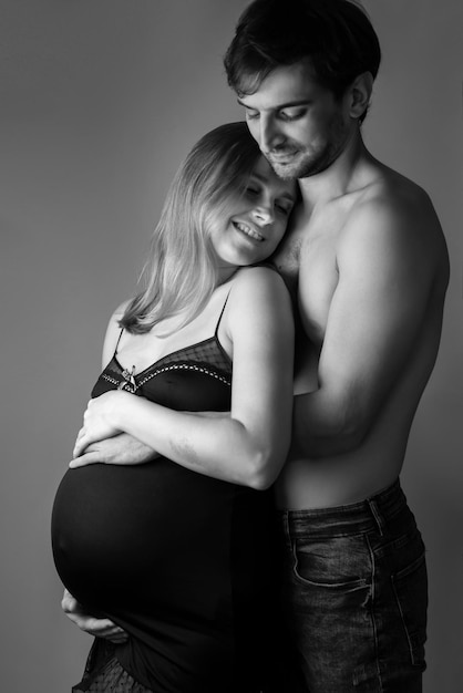 Giovane donna incinta e uomo felice sullo sfondo