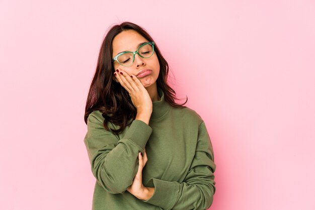 Giovane donna ispanica di razza mista isolata che è annoiata, affaticata e ha bisogno di una giornata di relax.