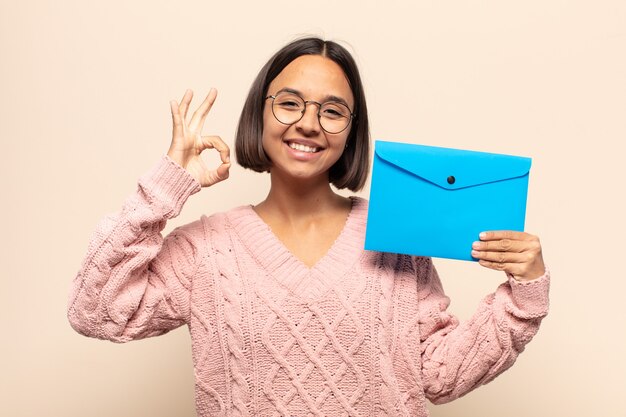 Giovane donna latina che si sente felice, rilassata e soddisfatta, mostrando l'approvazione con il gesto giusto, sorridendo