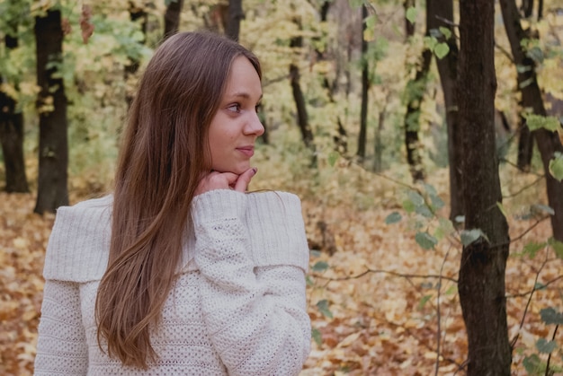 Giovane donna nel bellissimo parco autunnale