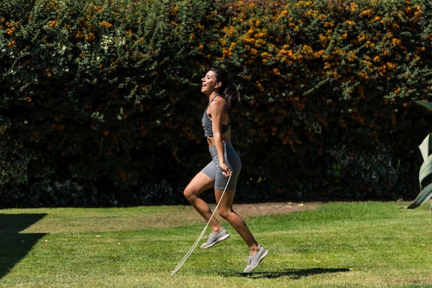 Giovane e bella donna che fa ginnastica nel giardino di casa sua in una giornata di sole dieta yoga