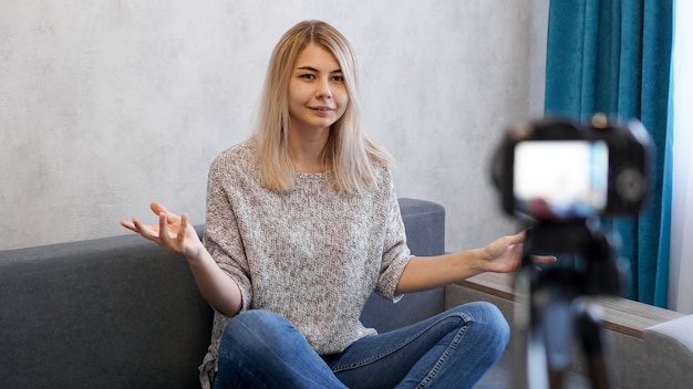 Giovane e intelligente. Bella giovane donna in abbigliamento casual durante la registrazione di video blod