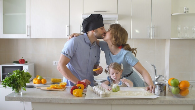 Giovane famiglia felice che spende tempo nella cucina.