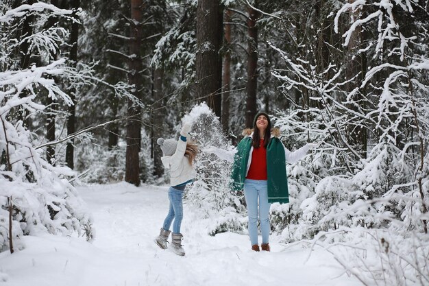 Giovane famiglia per una passeggiata Mamma e figlia stanno camminando in un parco invernale