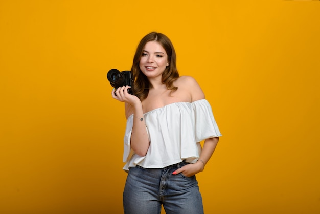 Giovane fotografo femminile con fotocamera isolata