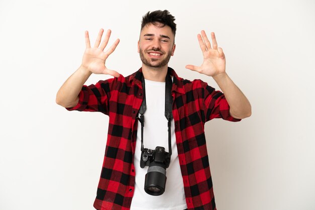 Giovane fotografo uomo caucasico isolato su sfondo bianco contando nove con le dita