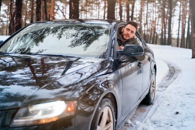 giovane in auto strada invernale