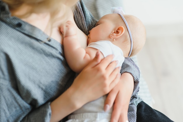 Giovane madre che allatta al seno il suo bambino appena nato a casa