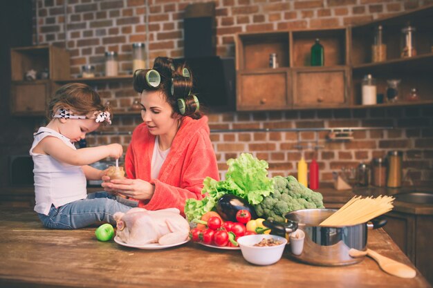 Giovane madre con bambino piccolo nella cucina di casa