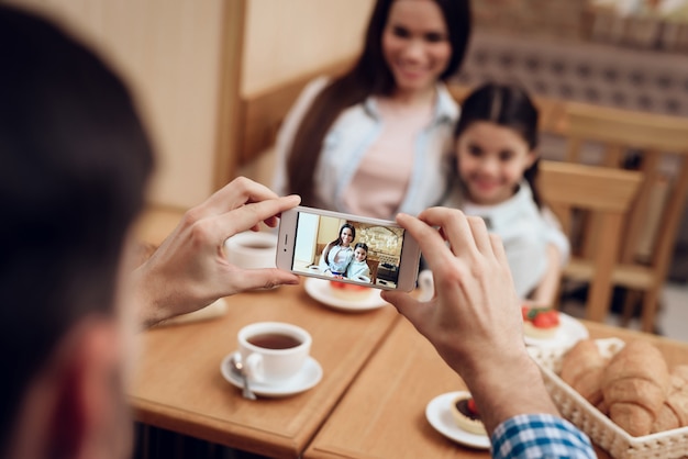 Giovane padre che prende foto della famiglia in self-service.