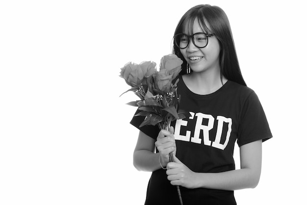 giovane ragazza adolescente asiatica nerd con gli occhiali isolato contro il muro bianco in bianco e nero