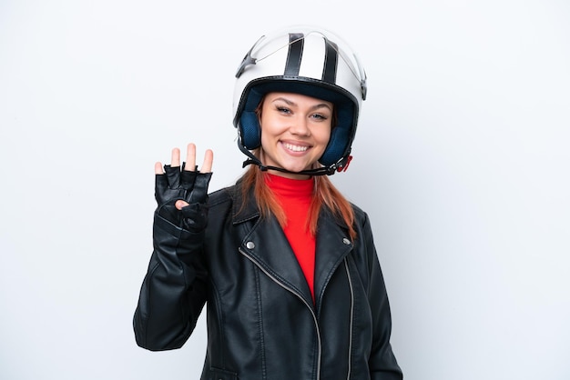 Giovane ragazza russa con un casco da motociclista isolato su sfondo bianco felice e contando quattro con le dita