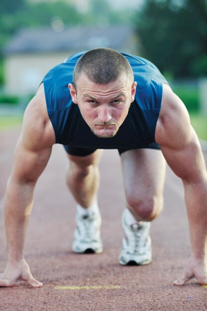 giovane sano alla linea di partenza pronto per correre e vincere