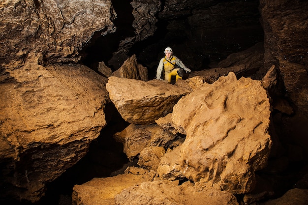 Giovane speleologo femminile che esplora la grotta