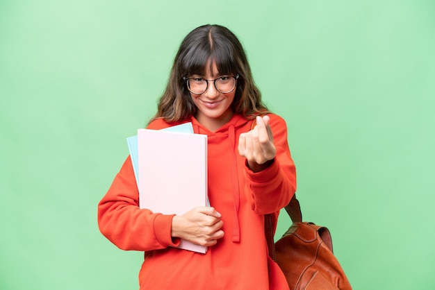 Giovane studente donna caucasica su sfondo isolato facendo gesto di denaro