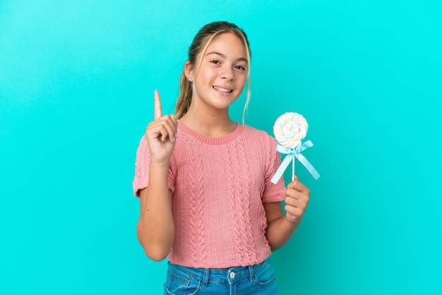 Giovane studentessa di razza mista che studia su un tavolo che punta con il dito indice una grande idea